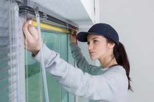 women measuring window for bespoke blinds